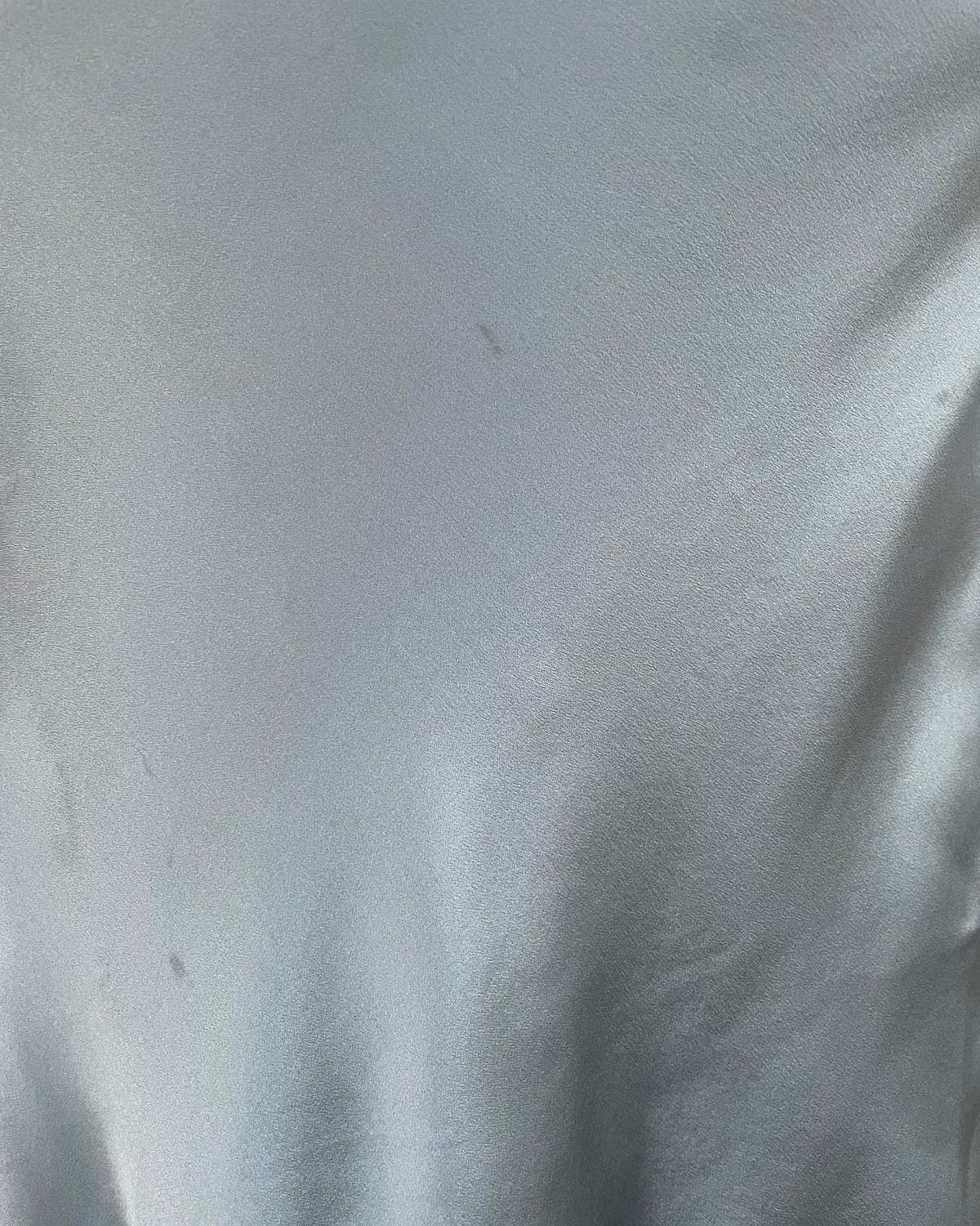 Macro detail of gray-blue silk fabric sheen and surface texture