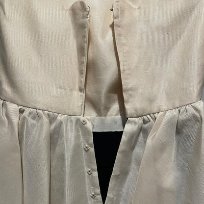 Interior detail of hook-and-eye and zipper at ivory bodice waist