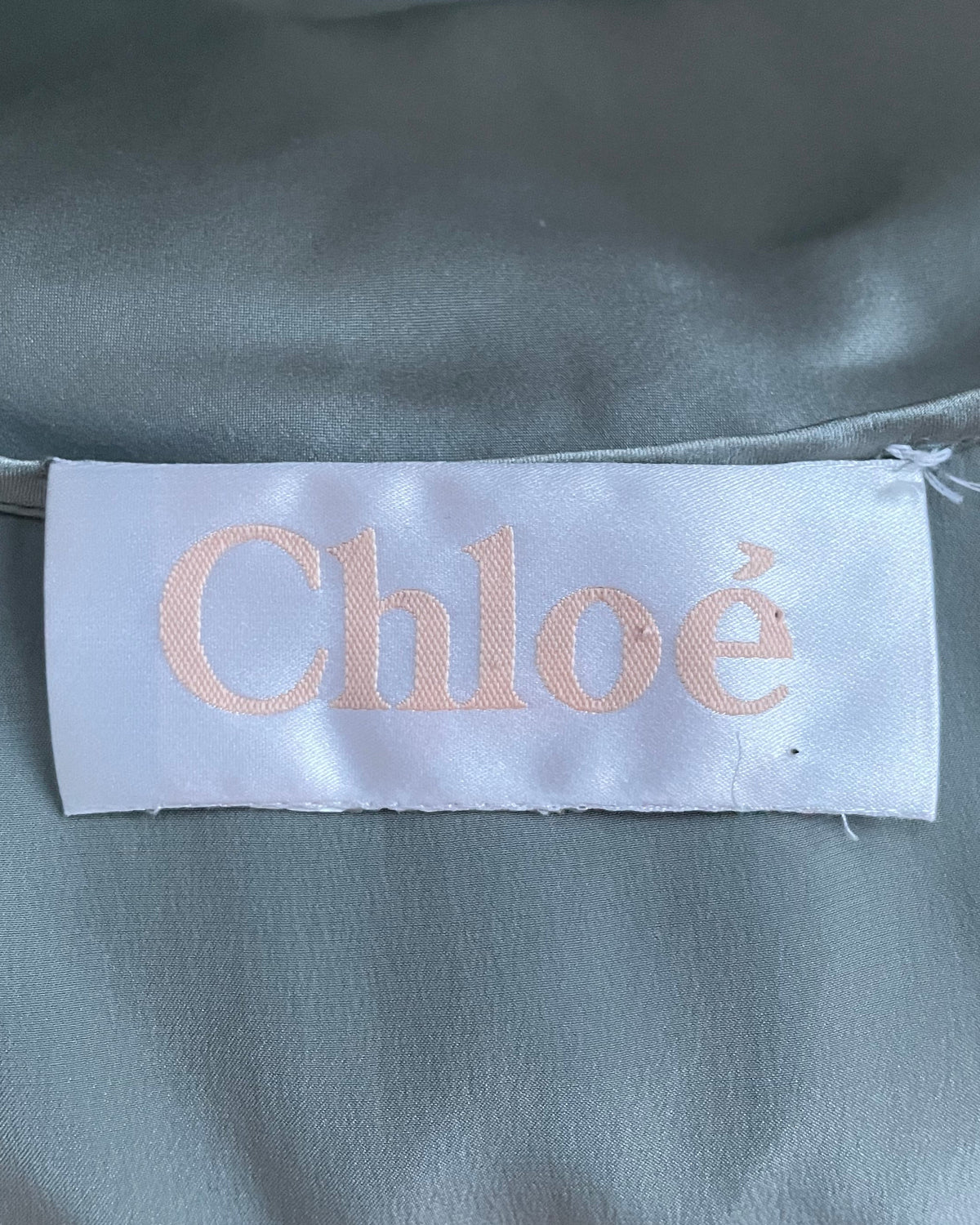 Interior Chloé brand label sewn into gray-blue silk fabric